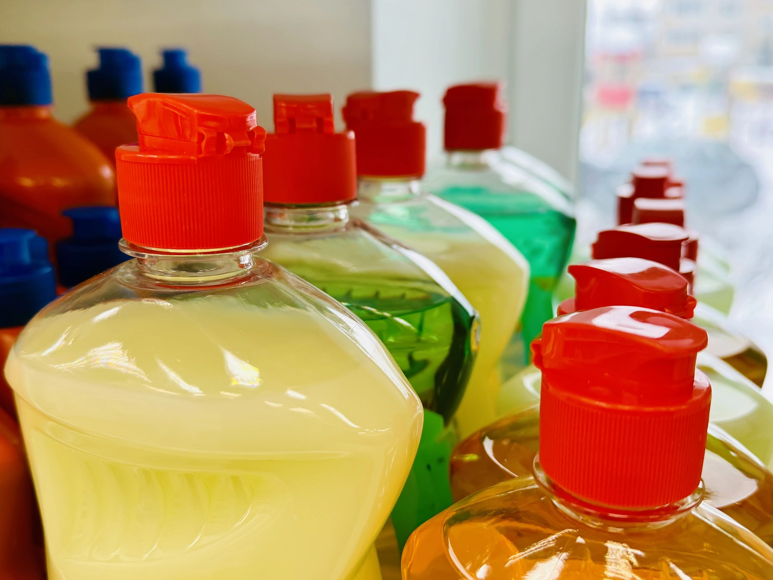 Neatly arranged dish soap bottles on a shelf